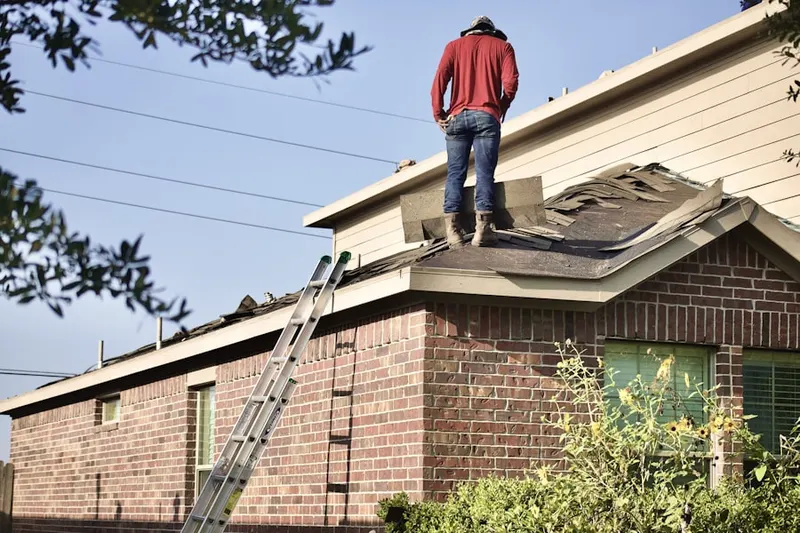 Professional roofer working on a residential roof in Wayside